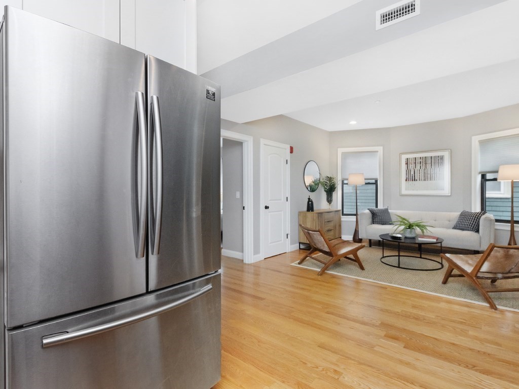286 Summer Street, Unit 2 Somerville, MA 02144 - Photo 8 of 37 a living room with stainless steel appliances furniture and a refrigerator