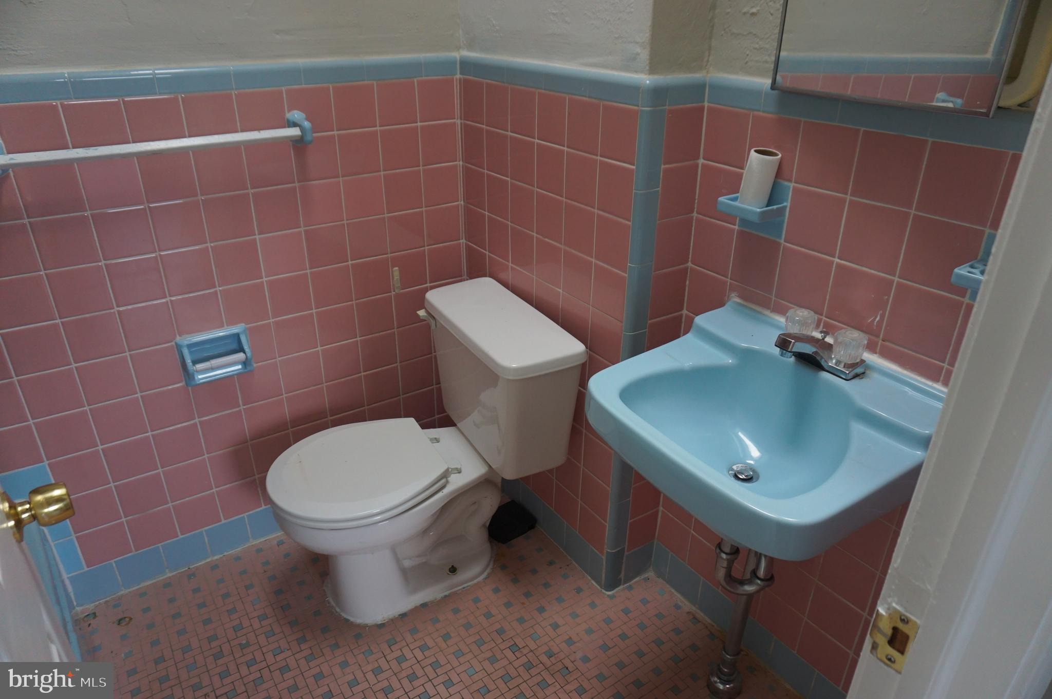 9041 Wesleyan Road Philadelphia, PA 19136 - Photo 11 of 35 a bathroom with a sink a toilet and a mirror