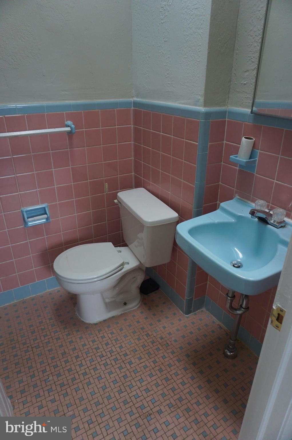 9041 Wesleyan Road Philadelphia, PA 19136 - Photo 12 of 35 a bathroom with a toilet a sink and a mirror