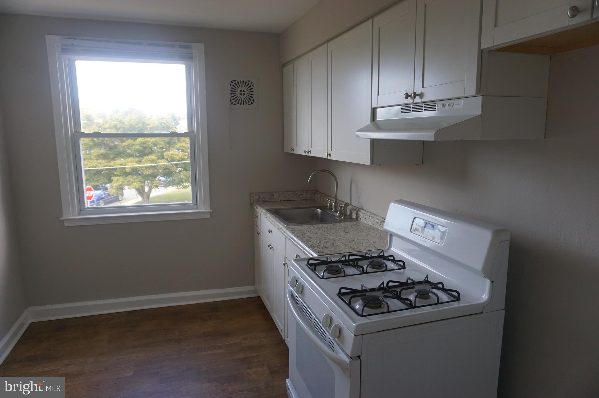 9041 Wesleyan Road Philadelphia, PA 19136 - Photo 13 of 35 a kitchen with granite countertop cabinets a stove and a sink