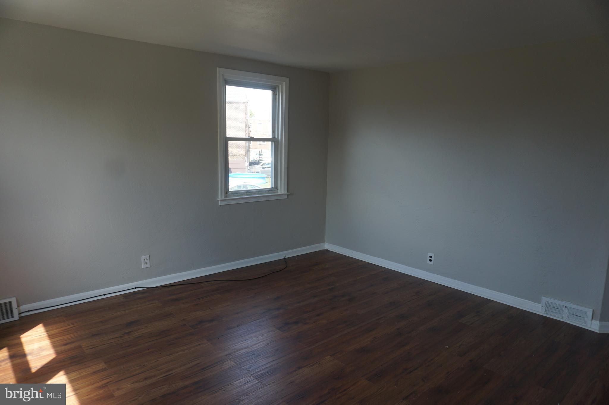 9041 Wesleyan Road Philadelphia, PA 19136 - Photo 19 of 35 an empty room with wooden floor and windows