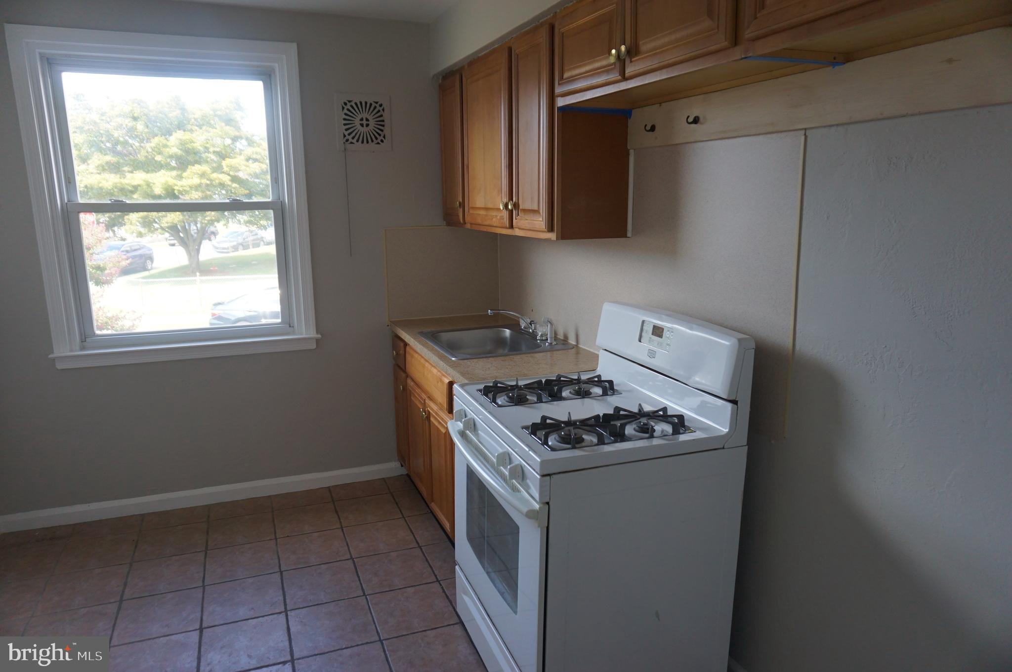 9041 Wesleyan Road Philadelphia, PA 19136 - Photo 20 of 35 a kitchen with a stove and a microwave