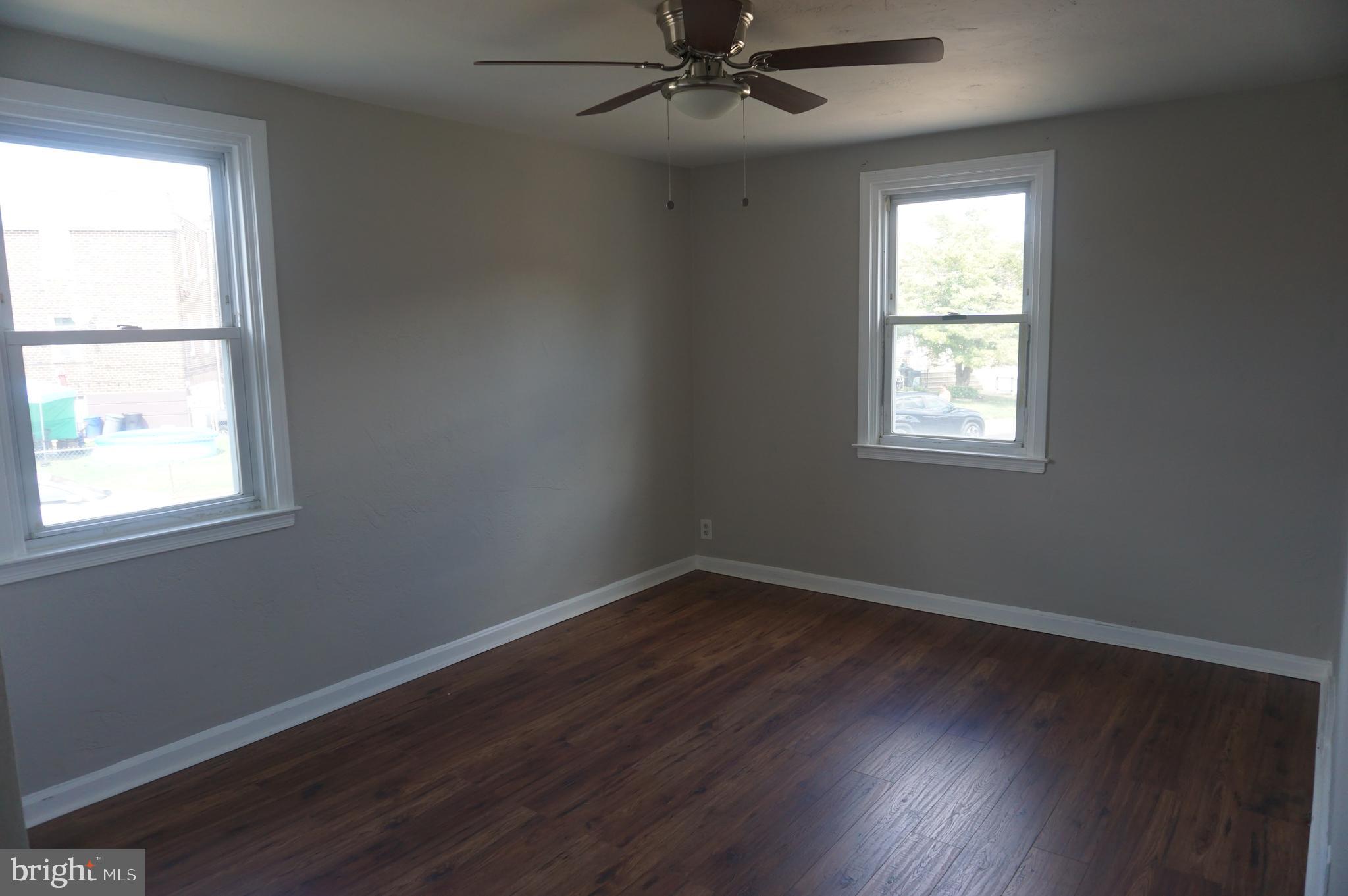 9041 Wesleyan Road Philadelphia, PA 19136 - Photo 21 of 35 an empty room with wooden floor windows and fan