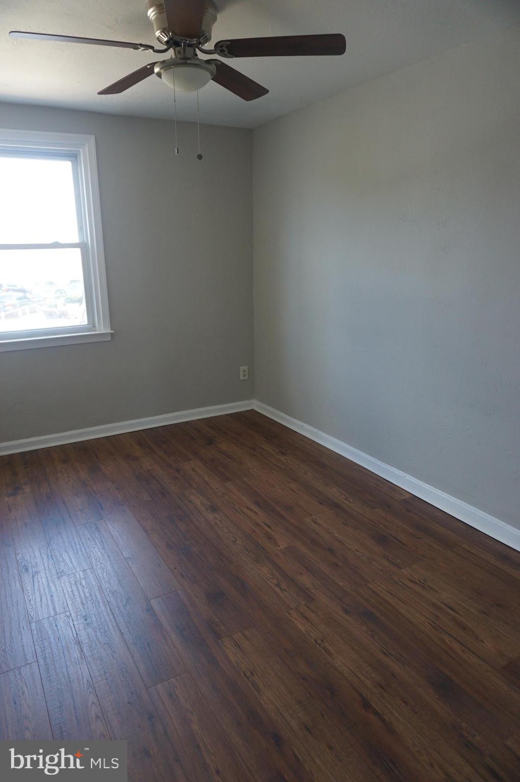 9041 Wesleyan Road Philadelphia, PA 19136 - Photo 22 of 35 an empty room with wooden floor windows and fan