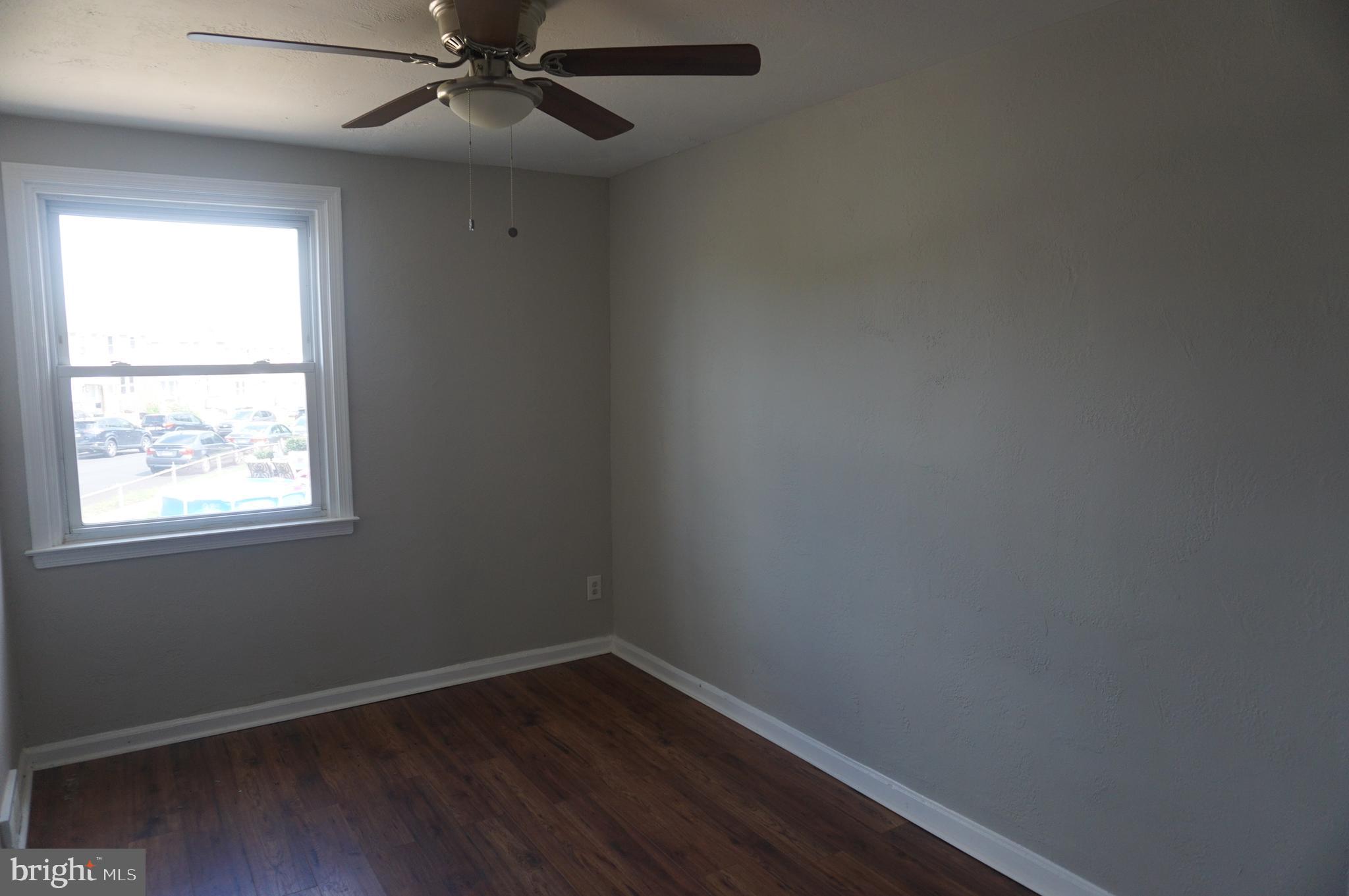 9041 Wesleyan Road Philadelphia, PA 19136 - Photo 23 of 35 an empty room with a window and wooden floor