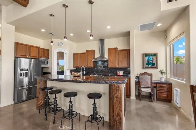 a kitchen with stainless steel appliances granite countertop a sink stove and cabinets