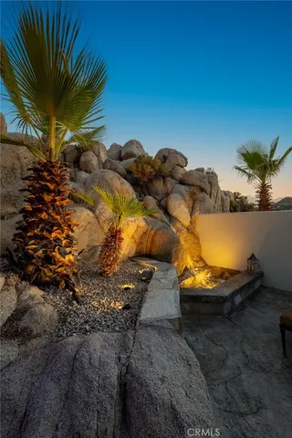 a backyard of a house with table and chairs