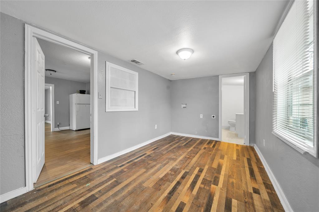 802 South Jackson Street Kaufman, TX 75142 - Photo 12 of 16 wooden floor in an empty room with a window