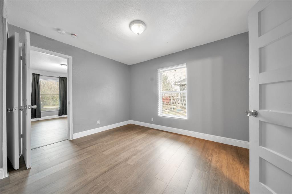 802 South Jackson Street Kaufman, TX 75142 - Photo 5 of 16 wooden floor in an empty room with a window