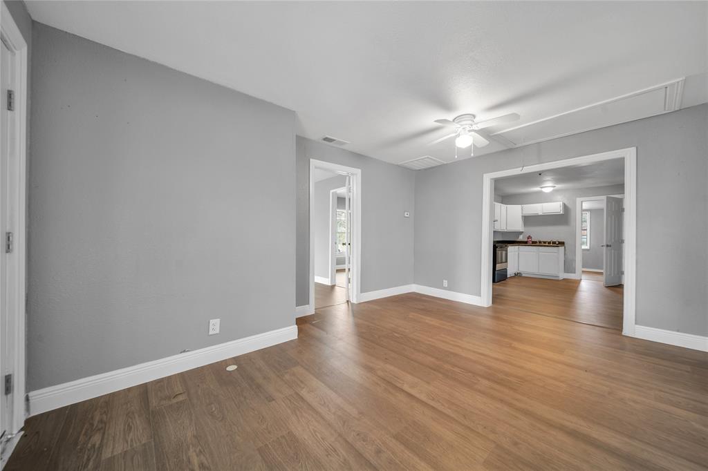 802 South Jackson Street Kaufman, TX 75142 - Photo 6 of 16 a view of an empty room with a window and wooden floor