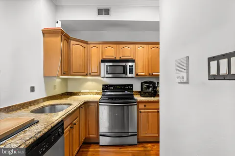 a kitchen with granite countertop a stove and a sink
