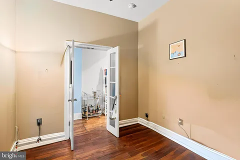 an empty room with wooden floor and a window