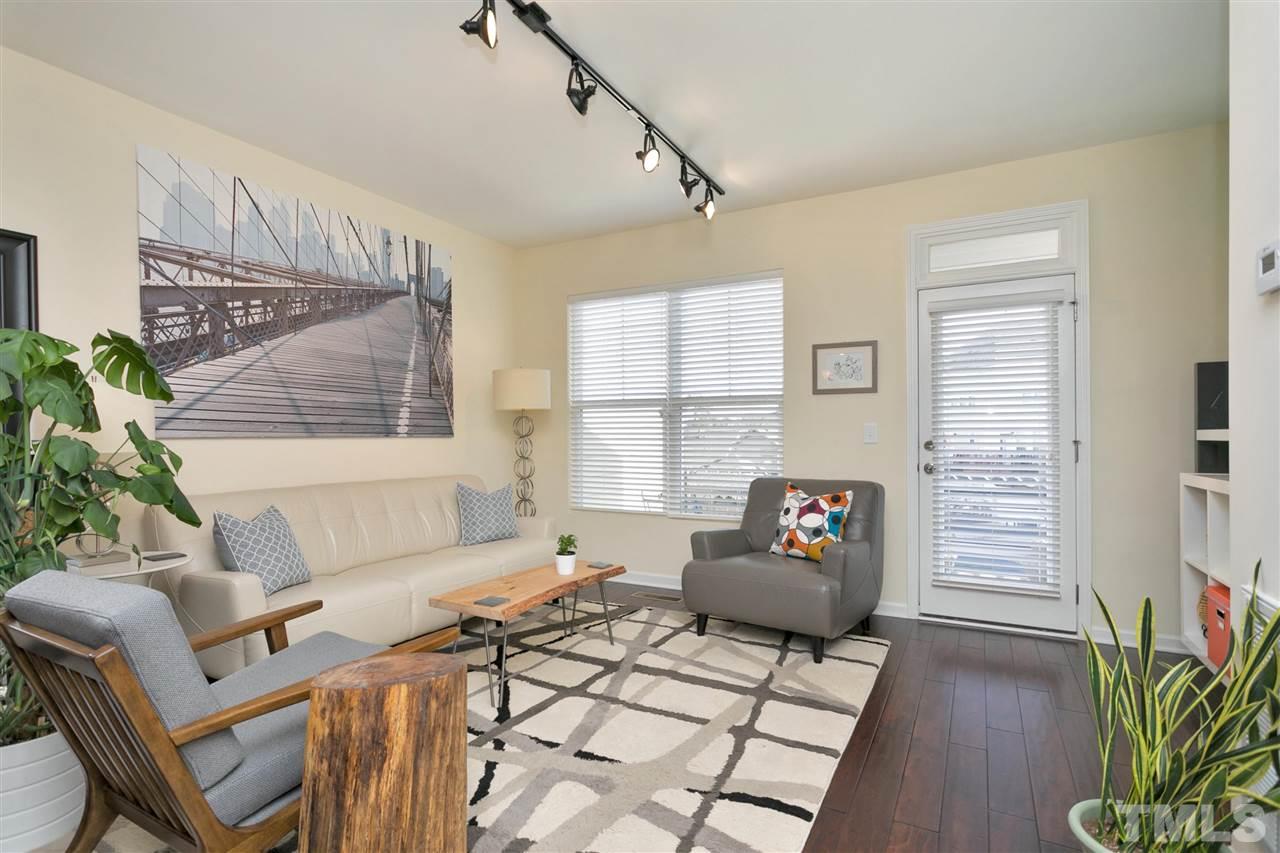 1412 Crafton Way Raleigh, NC 27607 - Photo 2 of 25 a living room with furniture and wooden floor
