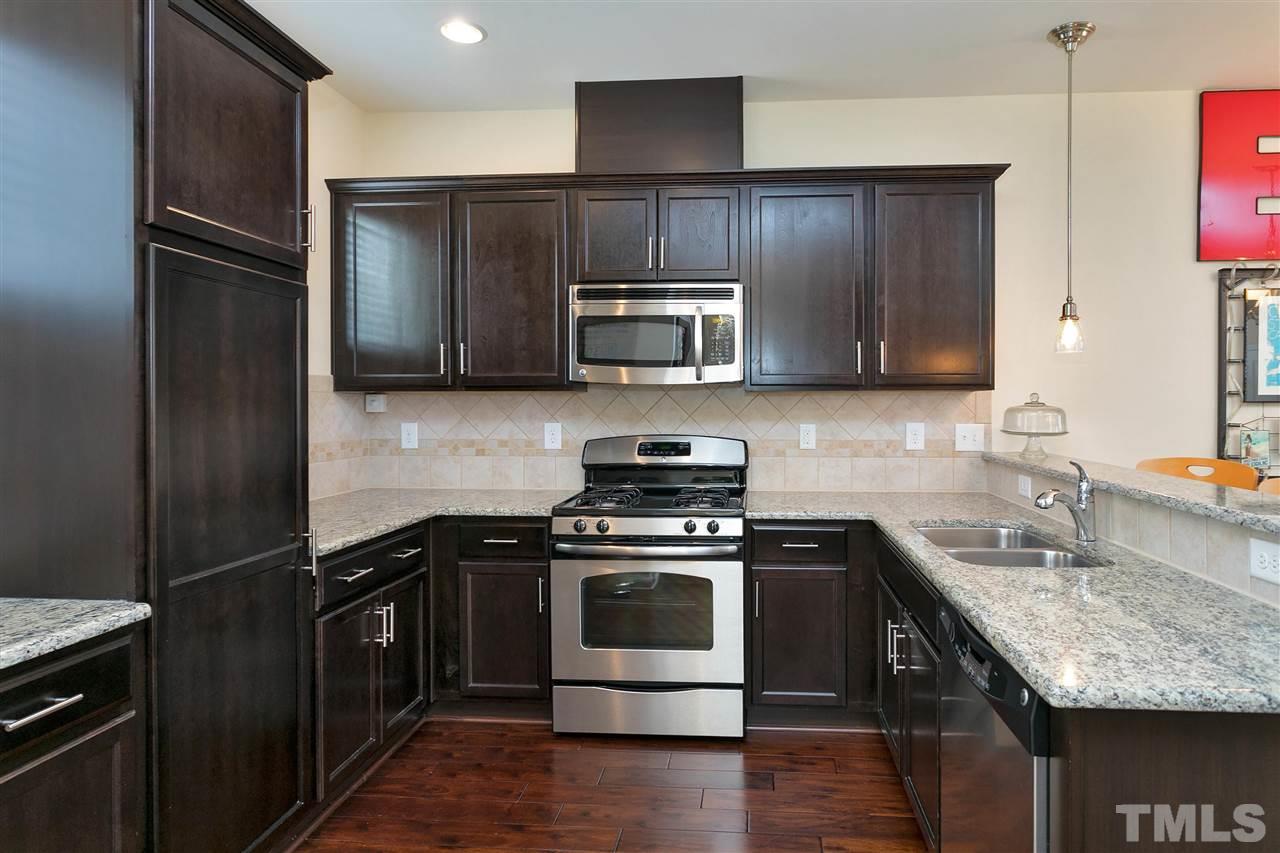1412 Crafton Way Raleigh, NC 27607 - Photo 11 of 25 a kitchen with a sink stove and refrigerator