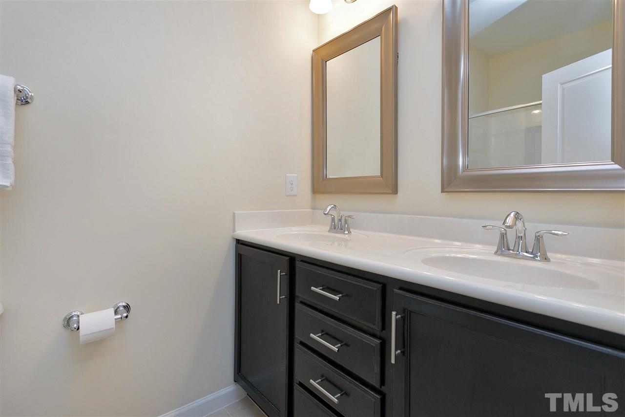 1412 Crafton Way Raleigh, NC 27607 - Photo 15 of 25 a bathroom with a sink and a mirror