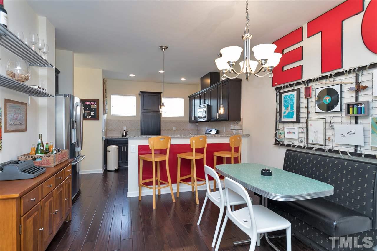 1412 Crafton Way Raleigh, NC 27607 - Photo 7 of 25 a dining room filled chandelier and wooden floors