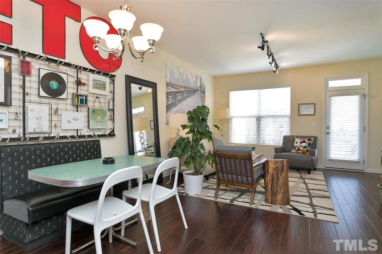 1412 Crafton Way Raleigh, NC 27607 - Photo 8 of 25 a view of a dining room with furniture a chandelier and wooden floor