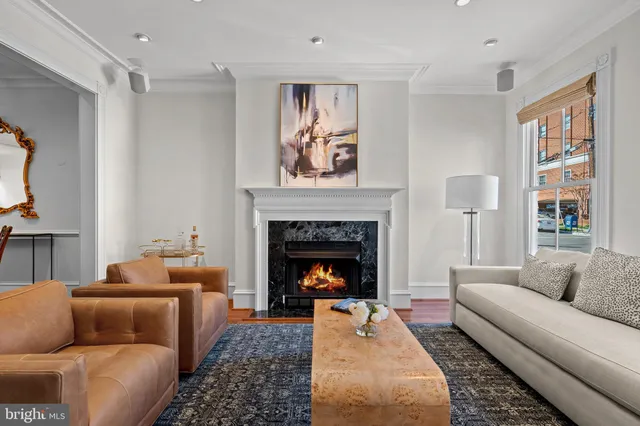 a living room with furniture fireplace and window