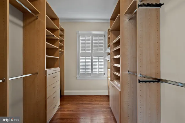 a view of walk in closet with empty racks