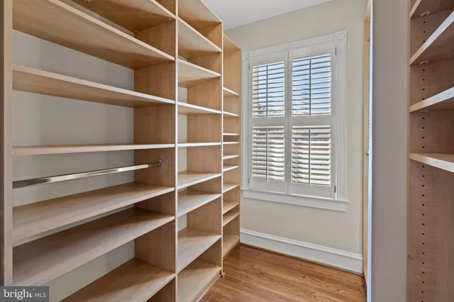 a view of walk in closet with empty racks