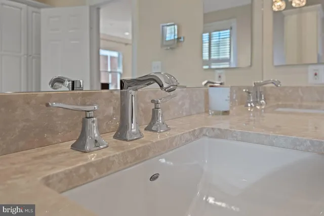 a bathroom with sink and mirror