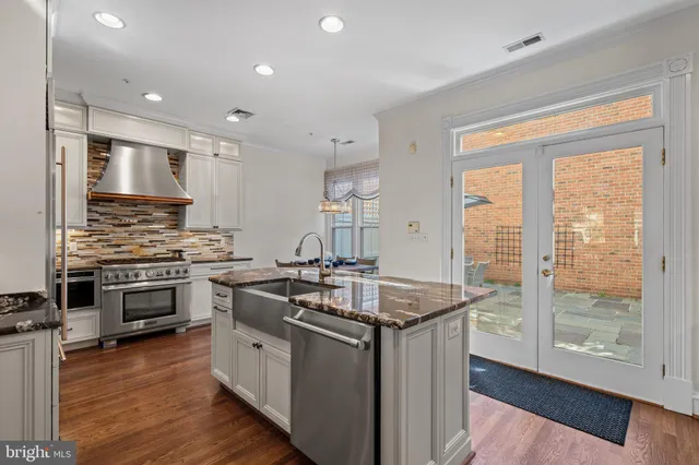 a kitchen with stainless steel appliances granite countertop a stove and a sink
