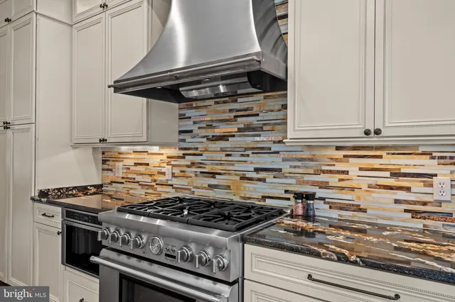 a stove top oven sitting inside of a kitchen