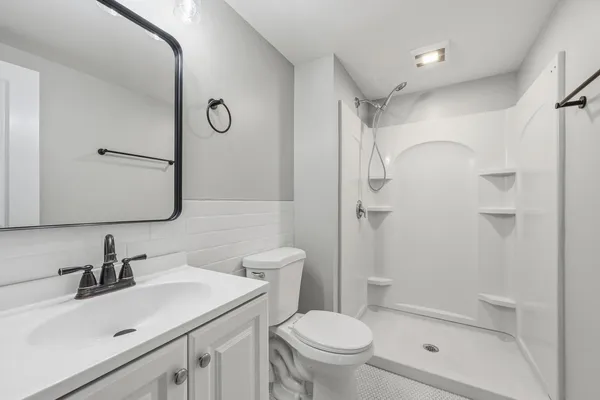 a bathroom with a sink toilet and shower