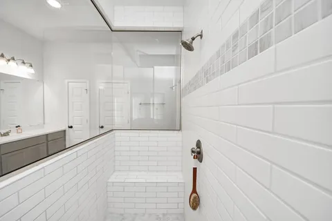 a large white kitchen with a sink and dishwasher a refrigerator with white cabinets