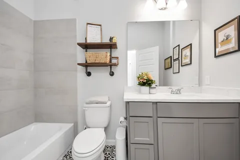 a bedroom with furniture a baby crib and a window