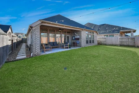 a view of a house with a yard and sitting area