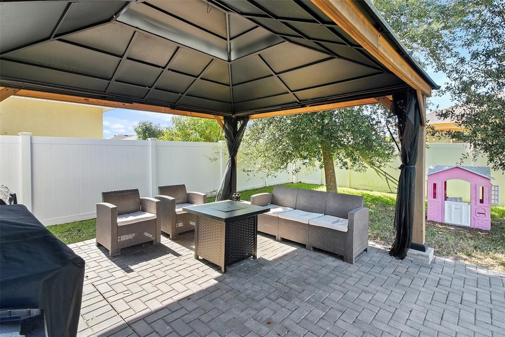 10121 Grande Loop Clermont, FL 34711 - Photo 19 of 30 a building outdoor space with patio furniture and garden