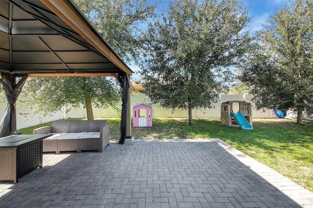10121 Grande Loop Clermont, FL 34711 - Photo 20 of 30 a backyard of a house with seating space