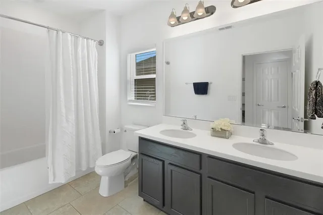 a bedroom with a chair and wooden floor