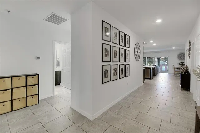 a large kitchen with stainless steel appliances a stove a sink cabinets and a dining table