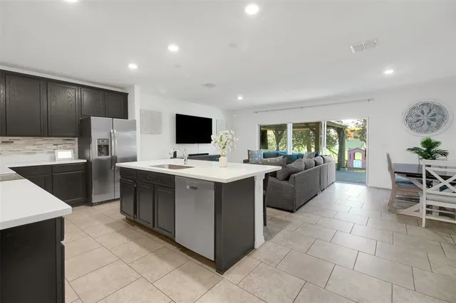 a kitchen with a sink stainless steel appliances and cabinets