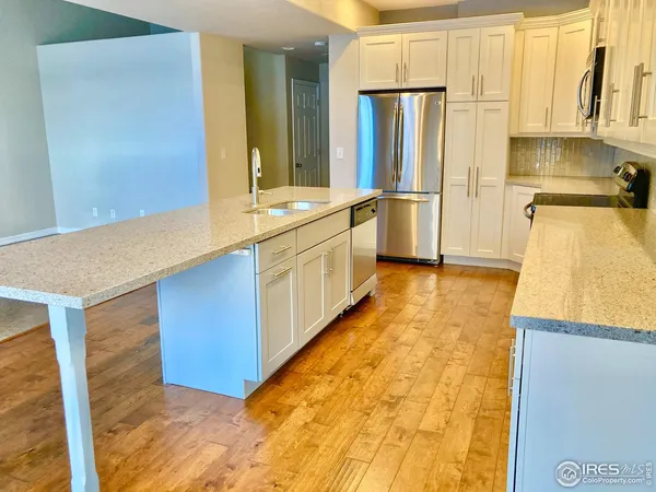 a kitchen with stainless steel appliances a refrigerator and a stove