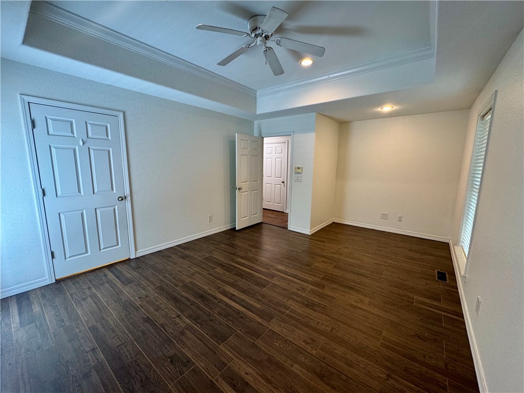 1197 Ridgeview Lane Russellville, AR 72802 - Photo 22 of 44 Spacious room featuring wood-finish flooring, a tray ceiling with a ceiling fan, recessed lighting, and a large window with blinds