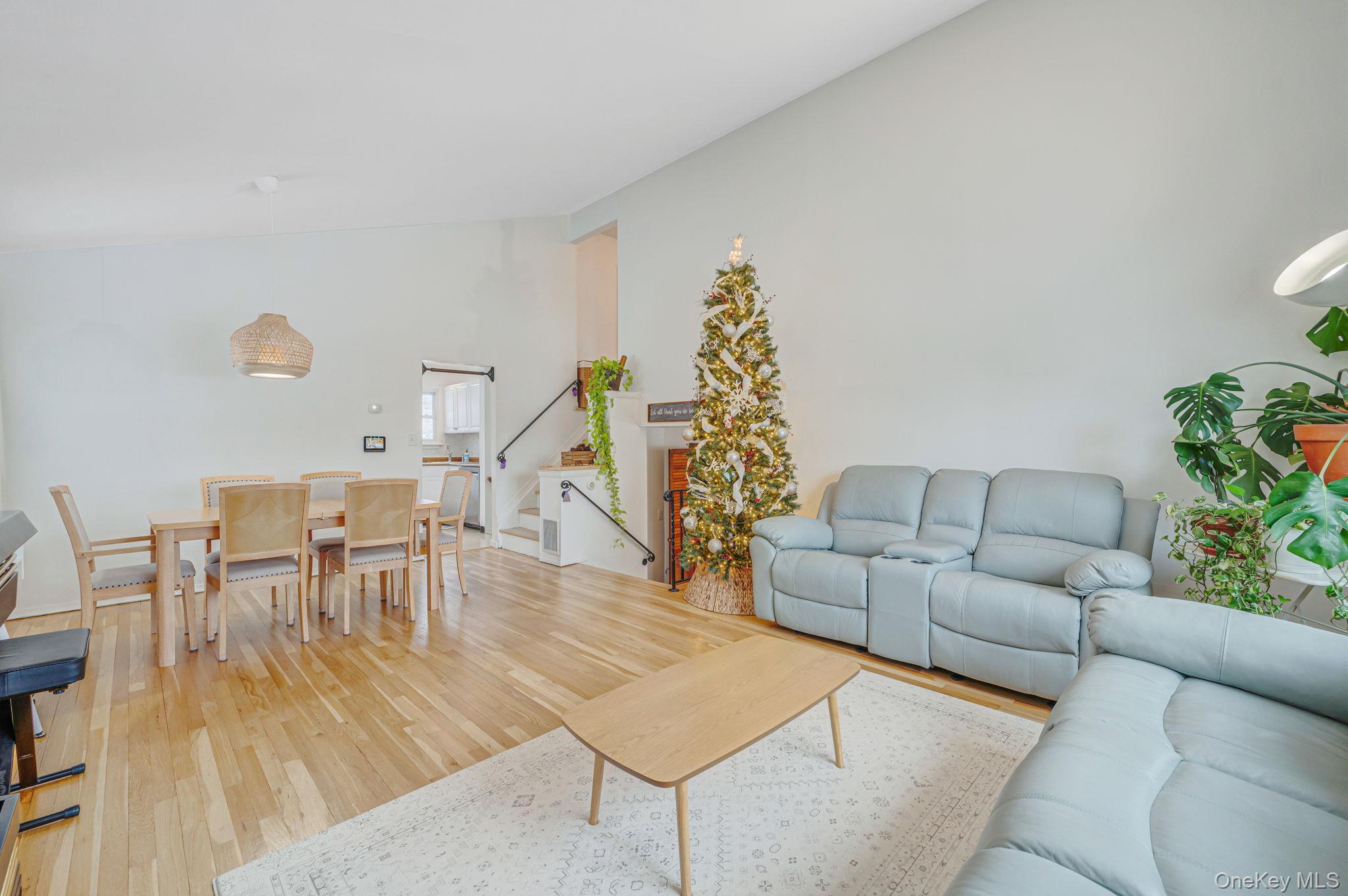 7 Seneca Drive Commack, NY 11725 - Photo 12 of 40 Main living room featuring light wood finished floors, stairs, and high vaulted ceiling