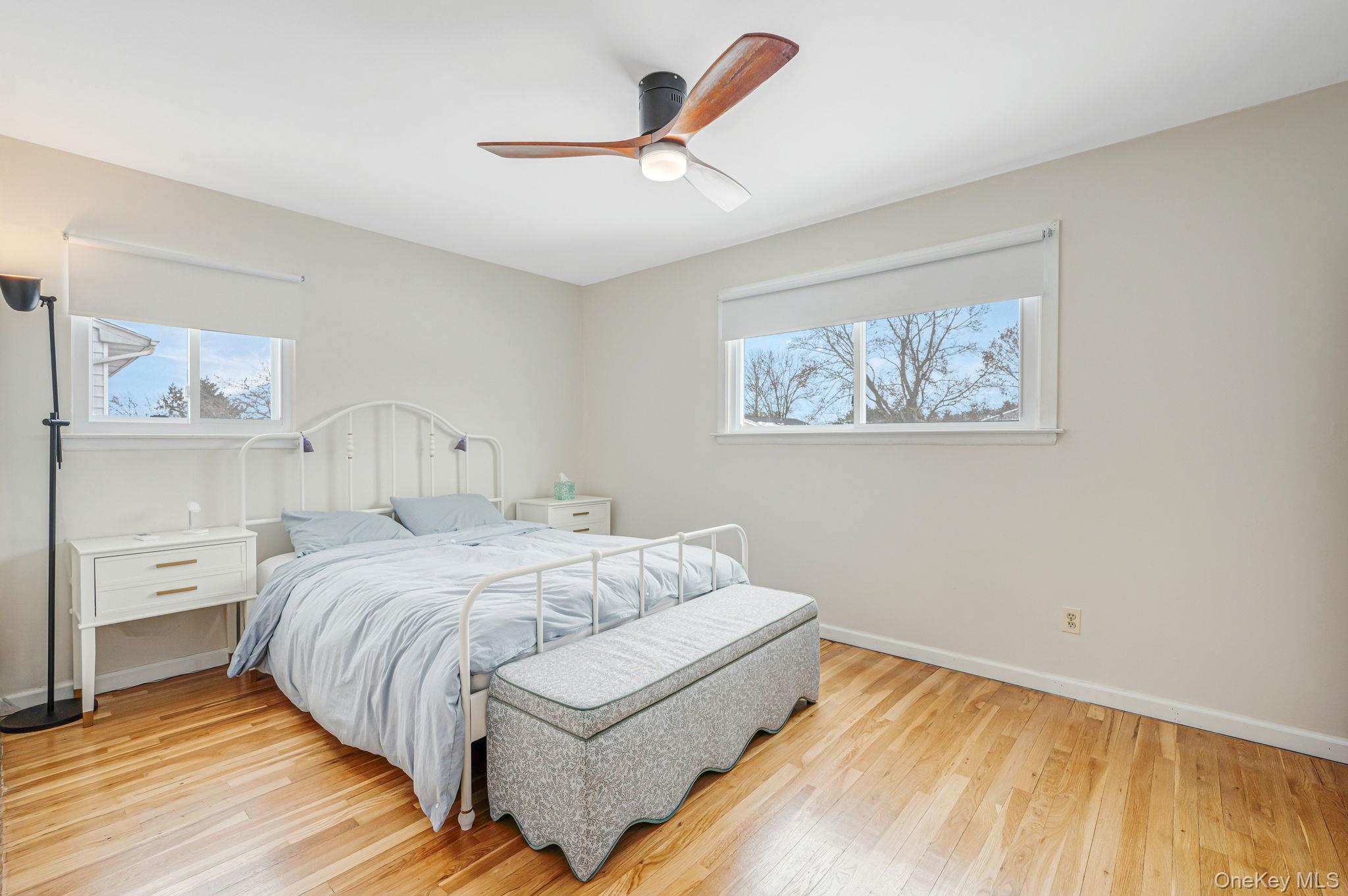 7 Seneca Drive Commack, NY 11725 - Photo 21 of 40 Primary bedroom with light wood finished floors and ceiling fan