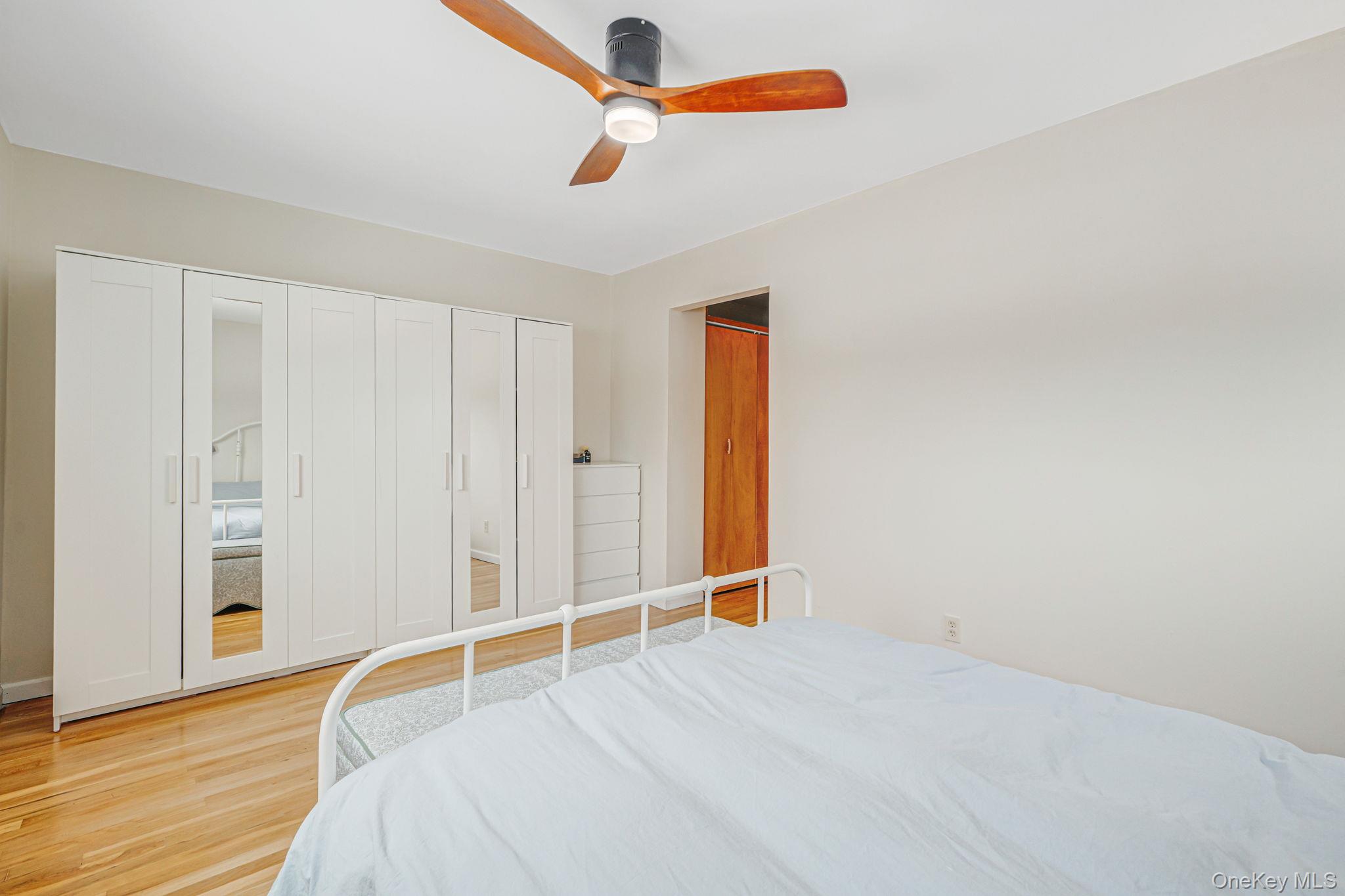 7 Seneca Drive Commack, NY 11725 - Photo 22 of 40 Primary bedroom featuring wood finished floors, ceiling fan, and a closet
