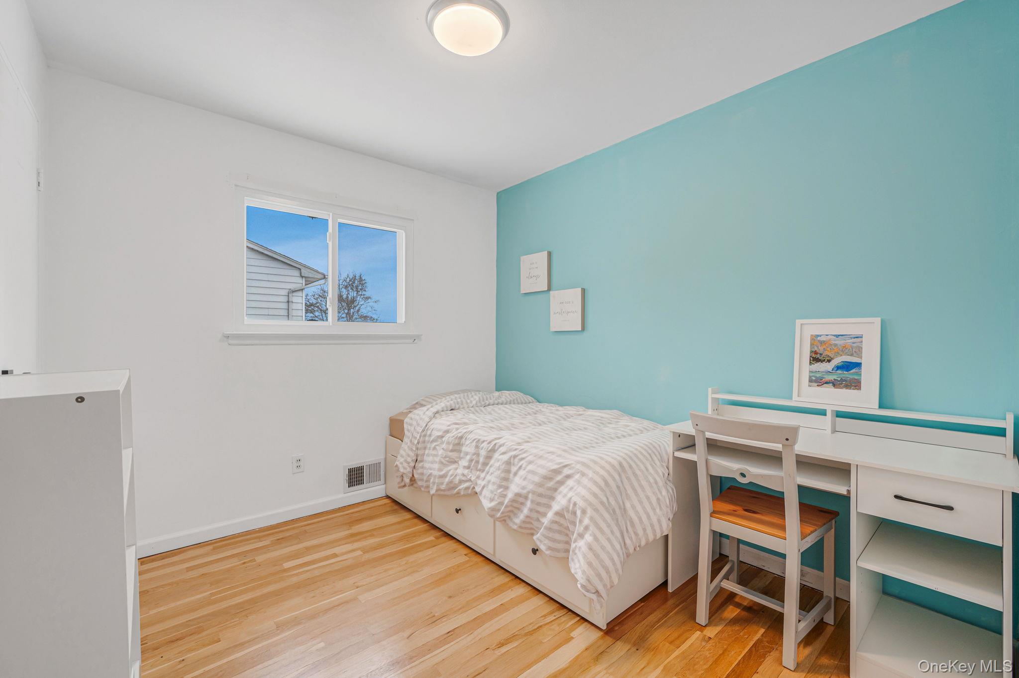 7 Seneca Drive Commack, NY 11725 - Photo 23 of 40 Bedroom featuring light wood-style flooring and baseboards