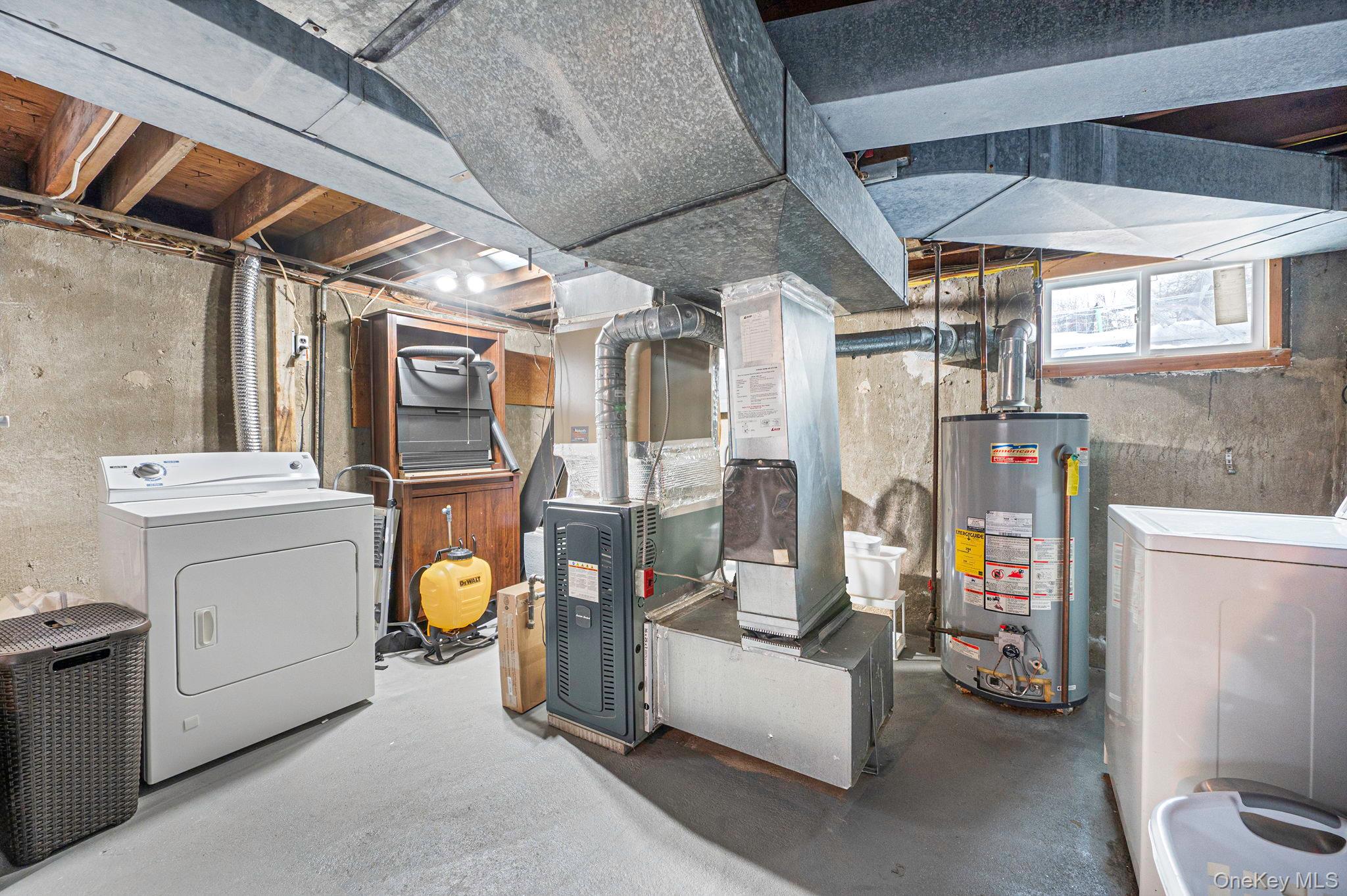 7 Seneca Drive Commack, NY 11725 - Photo 28 of 40 Unfinished basement featuring washer/dryer, water heater, and heating unit