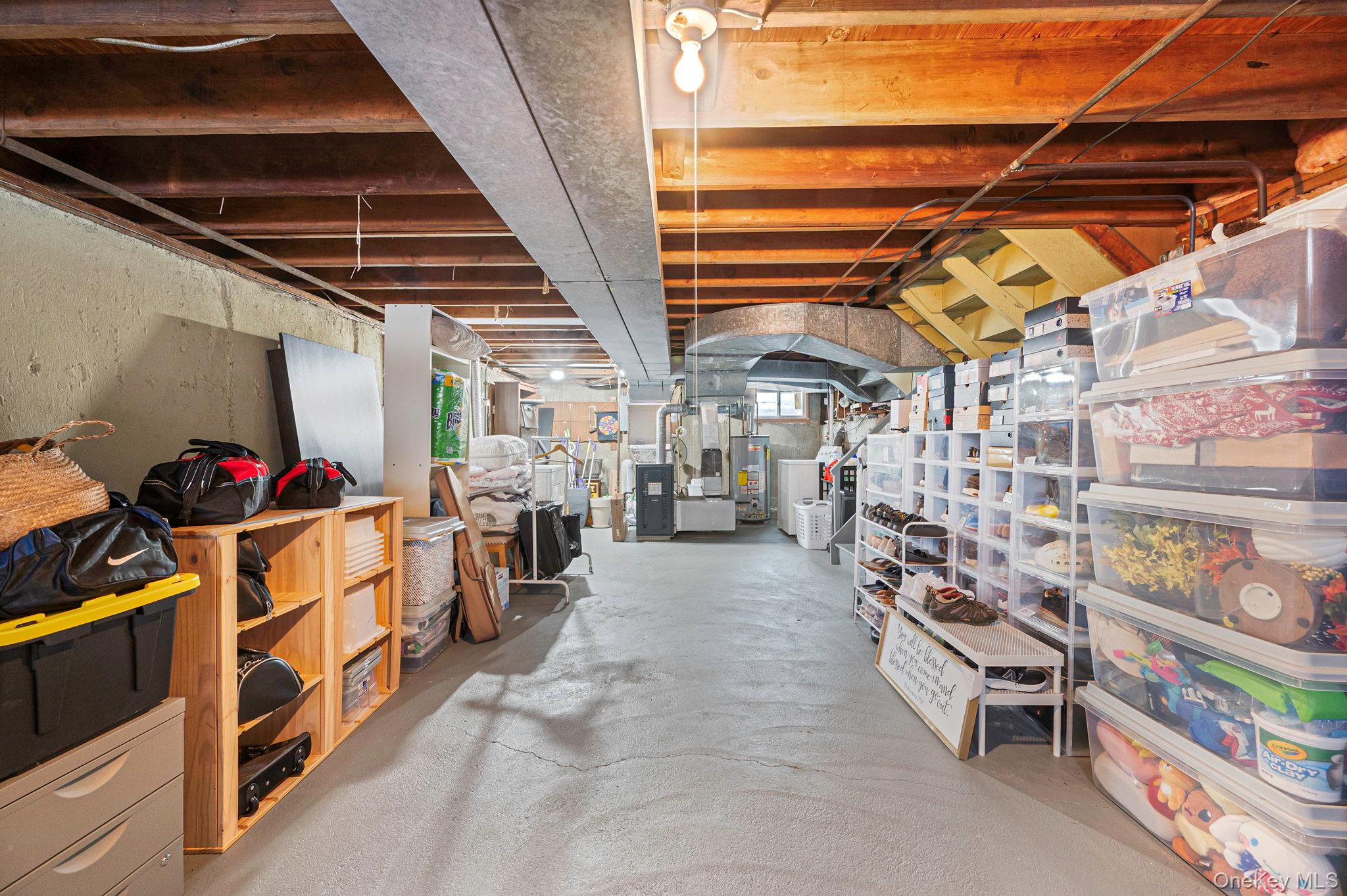 7 Seneca Drive Commack, NY 11725 - Photo 30 of 40 Unfinished basement featuring water heater