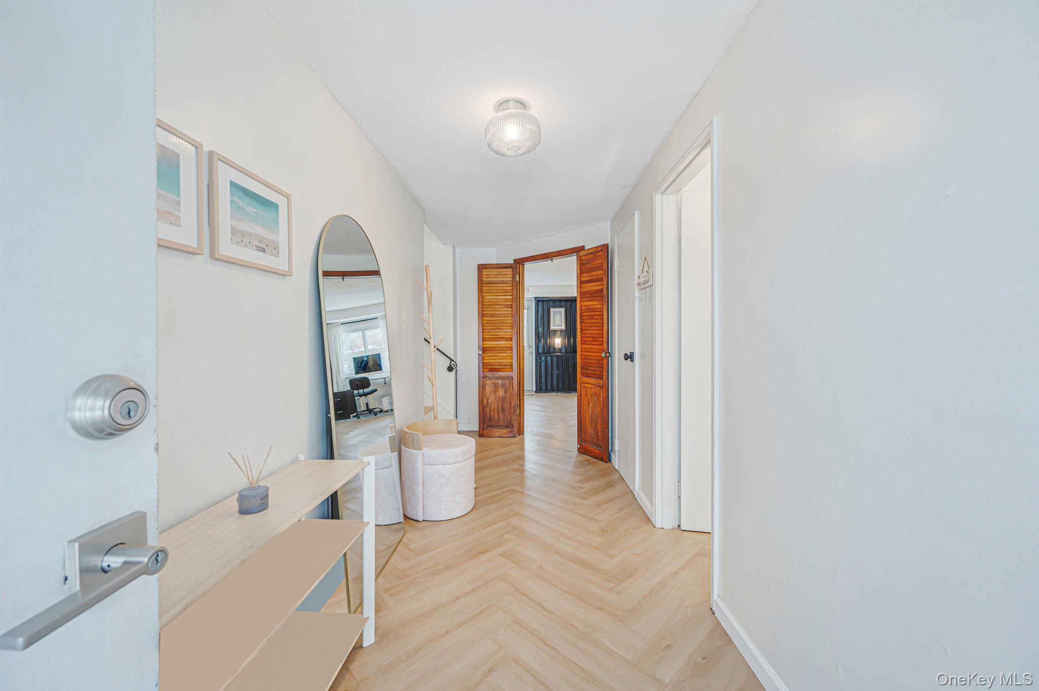 7 Seneca Drive Commack, NY 11725 - Photo 3 of 40 Corridor featuring arched walkways and baseboards