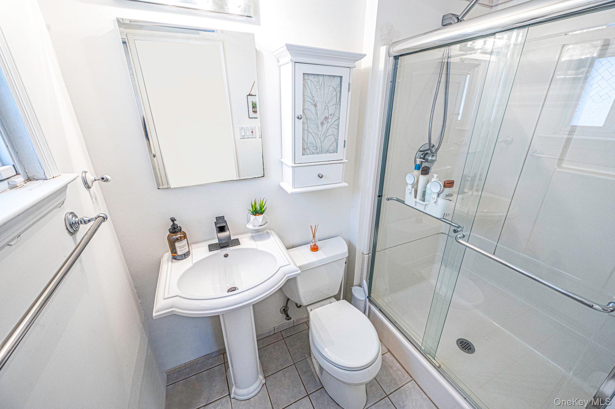 7 Seneca Drive Commack, NY 11725 - Photo 10 of 40 Bathroom with a shower stall and light tile patterned flooring