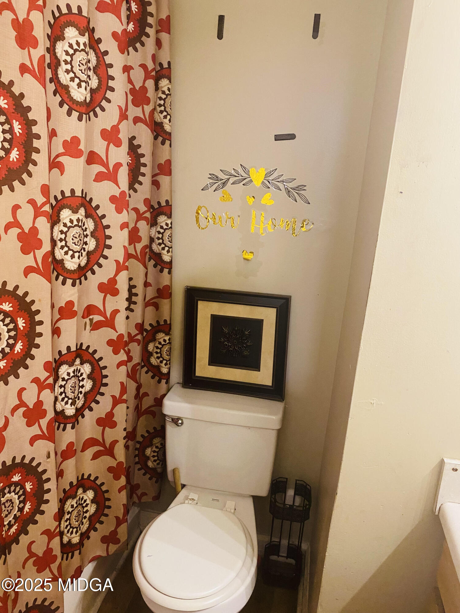 4496 Thrasher Circle Macon, GA 31206 - Photo 5 of 6 a white toilet sitting next to a shower curtain