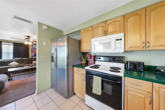 a kitchen with stainless steel appliances granite countertop a stove a refrigerator and a cabinets