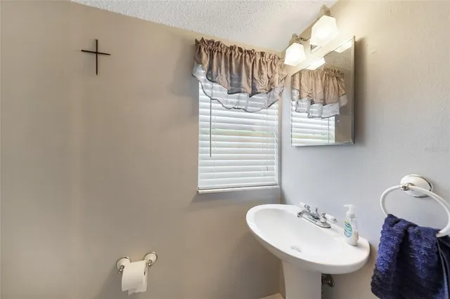 a bathroom with a sink a mirror and a toilet