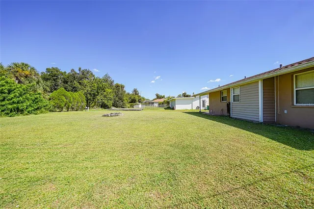a view of a house with pool yard and a yard